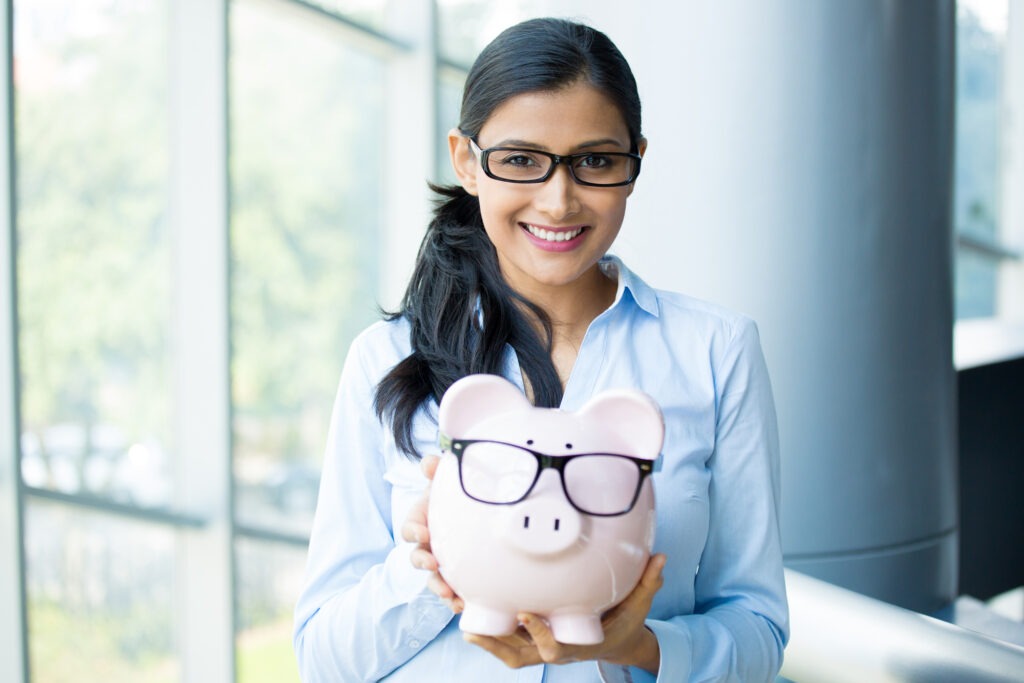 Smiling Business Woman With Piggy Bank